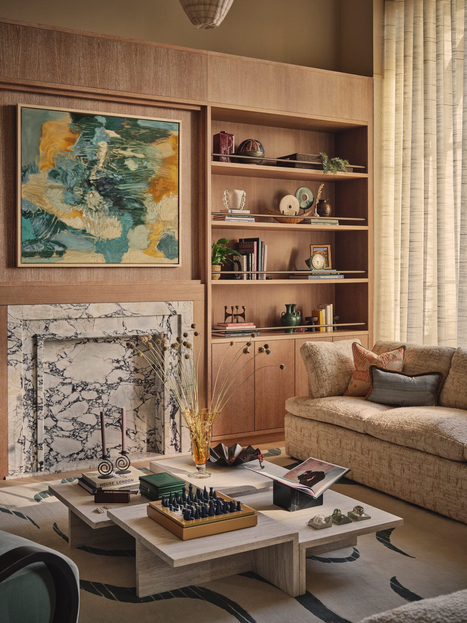 Living space with fireplace and display shelving at The Whiteley, Queensway