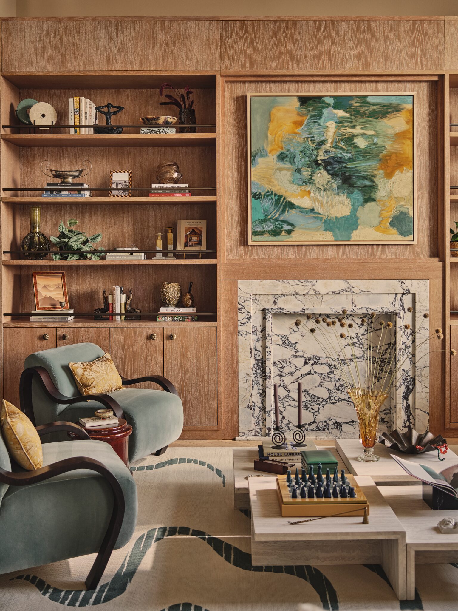 Living space with armchair and fireplace at The Whiteley, Queensway