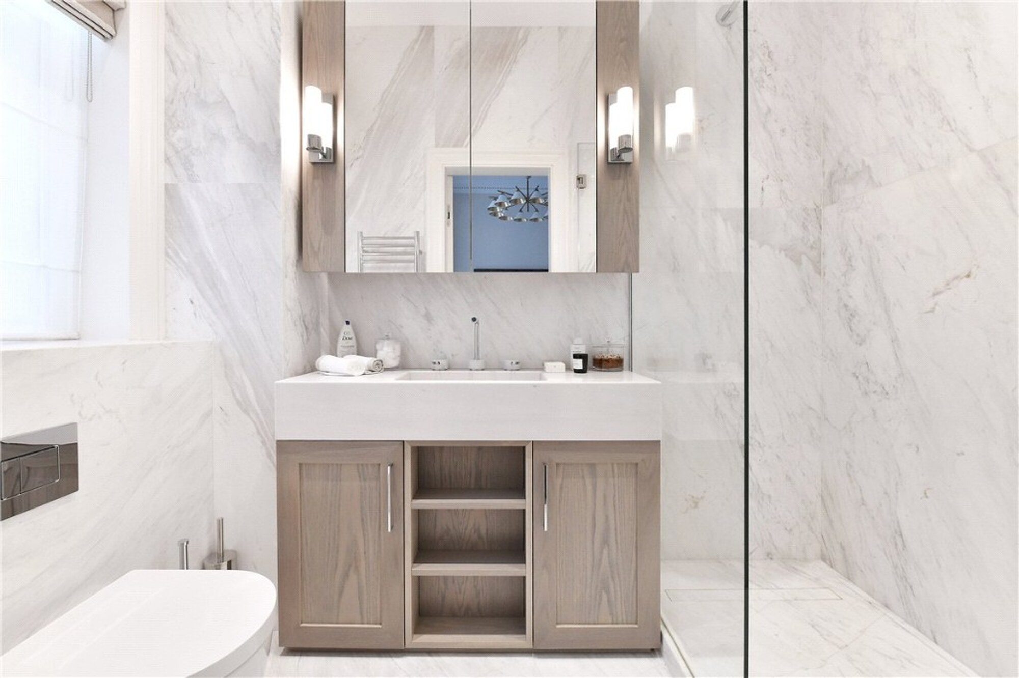 Marble bathroom on Mount Street with wooden vanity and walk-in shower