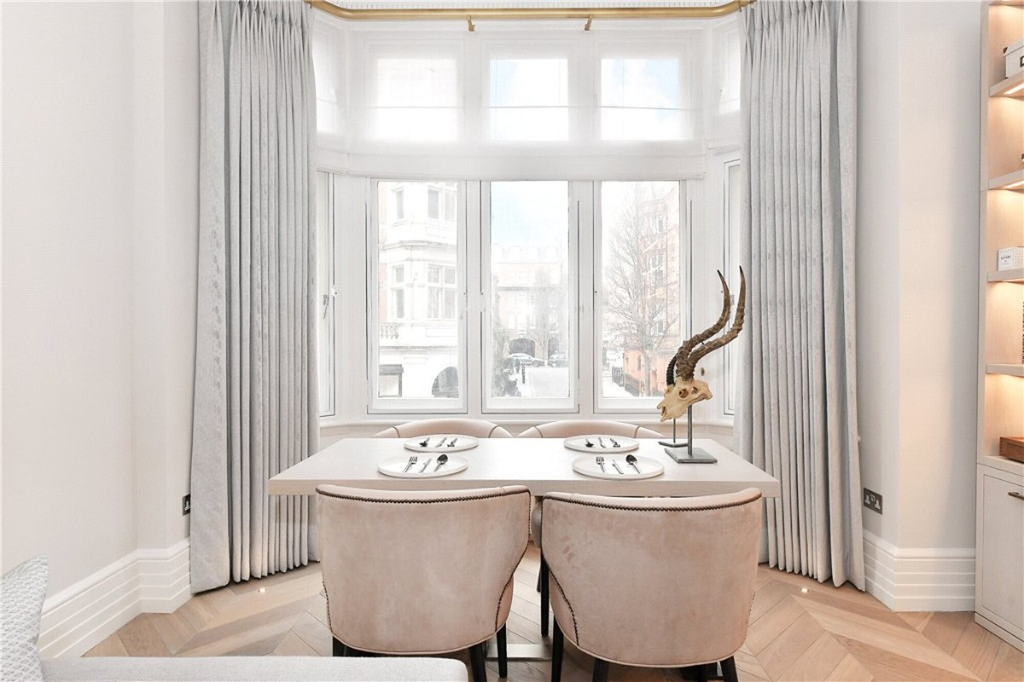 Dining table in a Mount Street bay window looking out to Mayfair